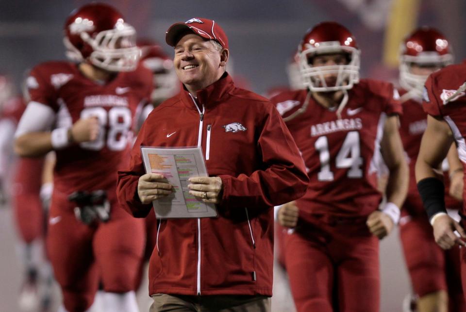 Arkansas coach Bobby Petrino runs onto the field before the start of the NCAA college football game with Texas-El Paso in Fayetteville, Ark., Saturday, Nov. 13, 2010. (AP Photo/Danny Johnston)