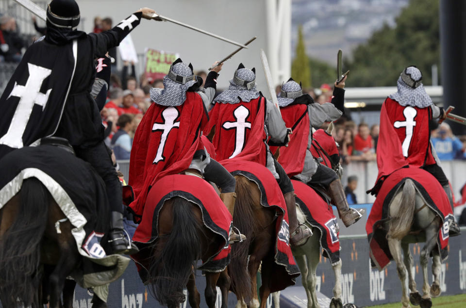 In this Feb. 23, 2019, file photo, the Crusader horseman ride around the arena prior to the start of the Super Rugby match between the Crusaders and Hurricanes in Christchurch, New Zealand. The Crusaders announced Wednesday, April 3, 2019, that they will be considering a change to their name and branding following the Christchurch terrorist attacks on March 15 - insisting the status quo is "no longer tenable." (AP Photo/Mark Baker, File)