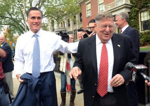 Republican presidential hopeful Mitt Romney greets former New Hampshire governor John Sununu (R) outside the New Hampshire Statehouse in October 2011. Sununu sneered that he wished Obama "would learn how to be an American" -- a comment that recalled previous attacks on the black president's identity and background