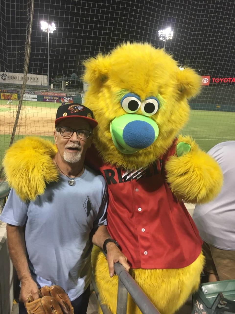 Mike Corbett with Fresno Grizzlies’ mascot, Parker, at a game in 2021.