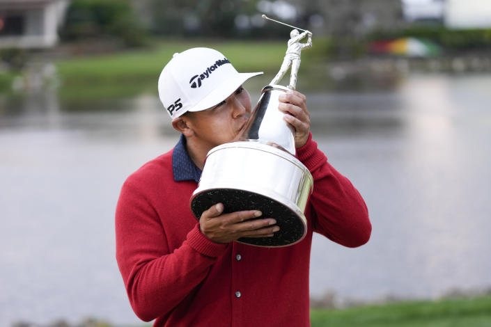 Kurt Kitayama kisses the championship trophy after winning the Arnold Palmer Invitational golf tournament Sunday, March 5, 2023, in Orlando, Fla. (AP Photo/John Raoux)