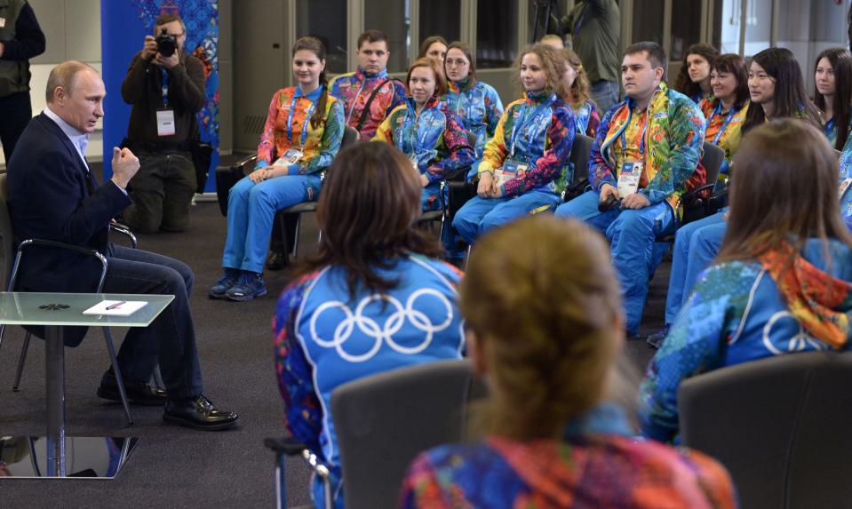 Russian President Vladimir Putin, left, speaks at his meeting with Olympic volunteers in the Black Sea resort of Sochi, Russia, Friday, Jan. 17, 2014. Putin says gays should feel welcome at the upcoming Winter Olympic Games in Sochi, but they must "leave the children in peace." Putin told volunteers Friday that gays visiting Sochi "can feel calm and at ease," and vowed that there would be no discrimination at the games. But he emphasized that, according to a law banning homosexual "propaganda" among minors, gays cannot express their views on gay rights issues to anyone underage. (AP Photo/RIA-Novosti, Alexei Nikolsky, Presidential Press Service)