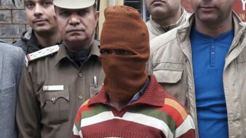 Rastogi being led to court while masked. Photo: Yahoo India.