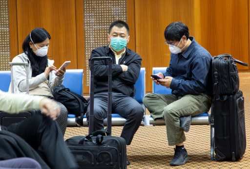 Passengers wearing masks to protect against the new coronavirus are pictured at Basra airport in southern Iraq in late January