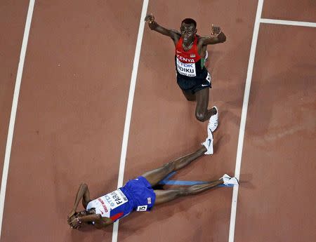 Mo Farah of Britain (L) and Caleb Mwangangi Ndiku of Kenya celebrate finishing first and second respectively in the men's 5,000 metres final during the 15th IAAF World Championships at the National Stadium in Beijing, China August 29, 2015. REUTERS/Fabrizio Bensch