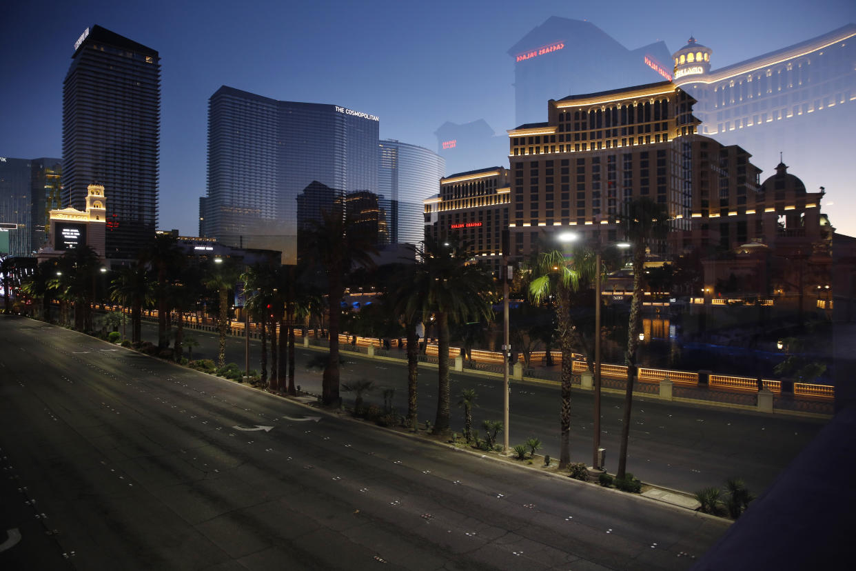 Photographed through glass, streets are empty of traffic along the Las Vegas Strip as casinos and other business are closed due to the coronavirus outbreak, Tuesday, April 14, 2020, in Las Vegas. (AP Photo/John Locher)