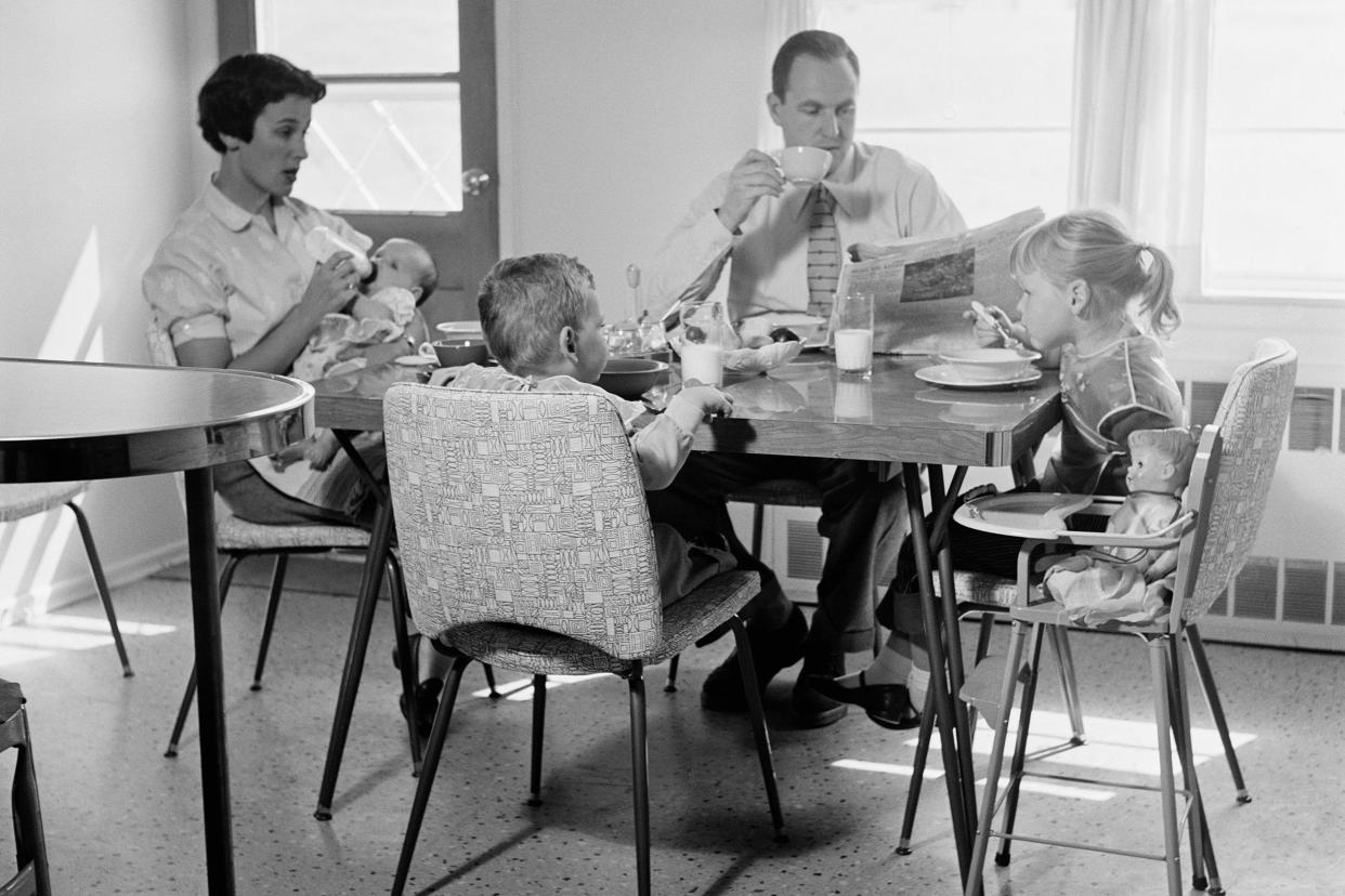 family of five eating breakfast at kitchen table