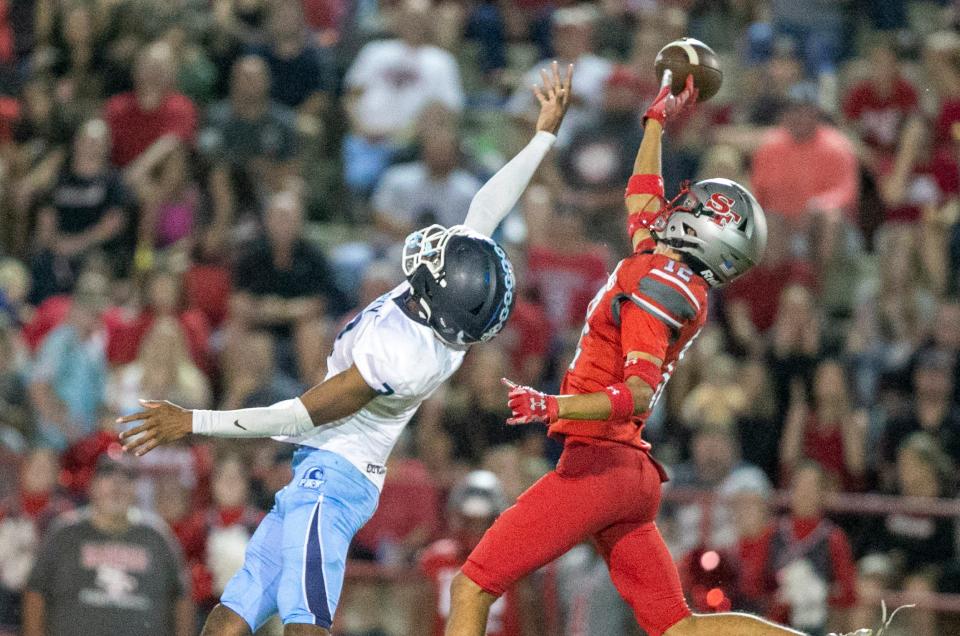 P. K. Yonge Thomas Young iii (3) and Santa Fe wide receiver Ben Hockman (12) reach for a pass as Santa Fe hosted PK Yonge Tuesday, Sept. 27, 2022, in Gainesville, Fla., Florida. [Alan Youngblood/Special to the Gainesville Sun]