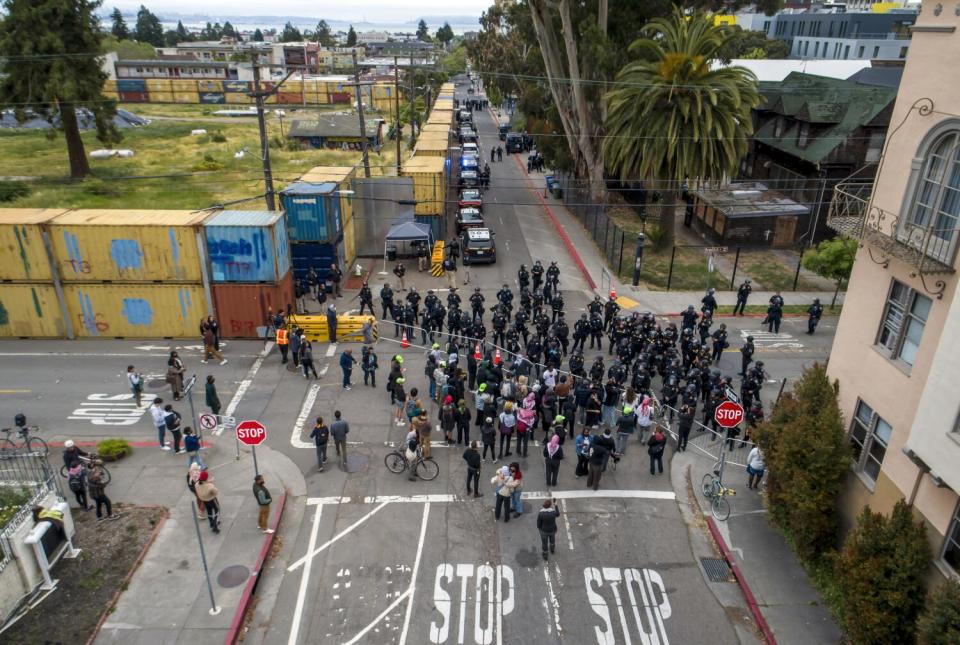 An aerial view of police and CHP officers blocking demonstrators on a Berkeley street