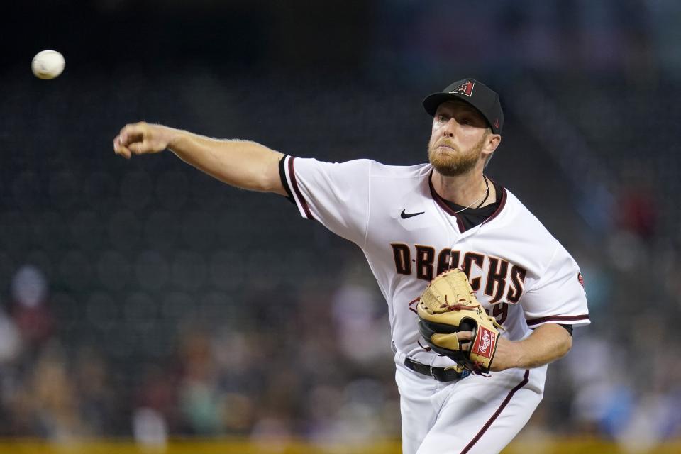 Arizona Diamondbacks starting pitcher Merrill Kelly throws against the Milwaukee Brewers during the first inning of a baseball game Monday, June 21, 2021, in Phoenix. (AP Photo/Ross D. Franklin)