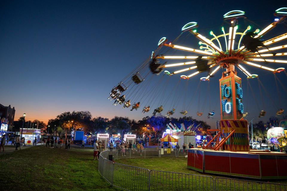 Kids ride the giant swings at the Georgefest Carnival in downtown Eustis.