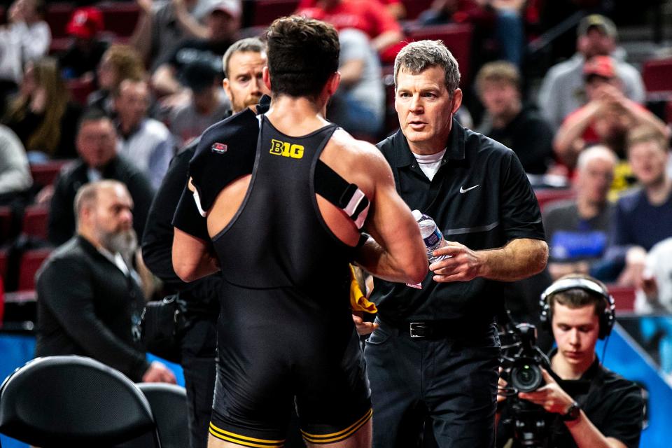 Iowa head coach Tom Brands, right, talks with Michael Kemerer after a match at 174 during the first session of the Big Ten Wrestling Championships, Saturday, March 5, 2022, at Pinnacle Bank Arena in Lincoln, Nebraska.