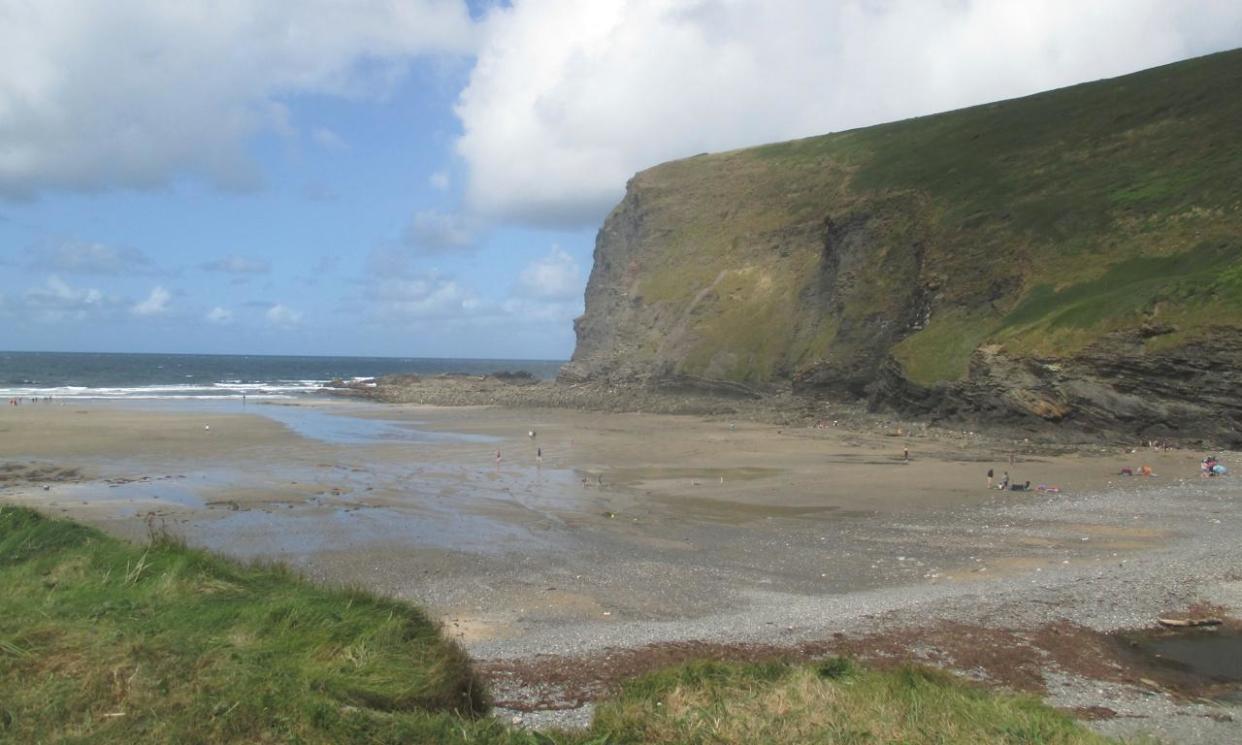 <span>Crackington Haven. ‘The tide is far out, the surf messy and rough, but visitors scatter across the shining sand.’</span><span>Photograph: Jack Spiers</span>