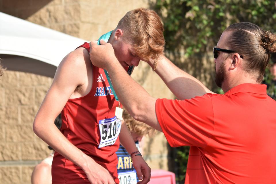 Martinsville's Martin Barco earns a medal for finishing fifth place in the 1,600-meter race during the IHSAA boys track and field state finals on June 4, 2022.