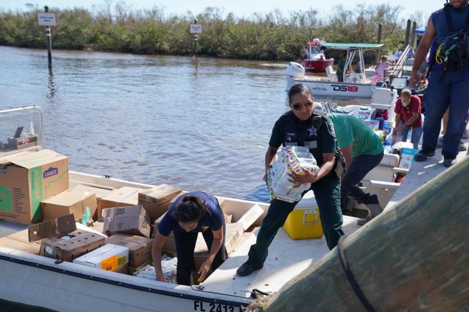 Lee County Sheriff Deputy Tricia Aponte unloads supplies arriving at Pine Island, Florida, on Monday, Oct. 3, 2022.