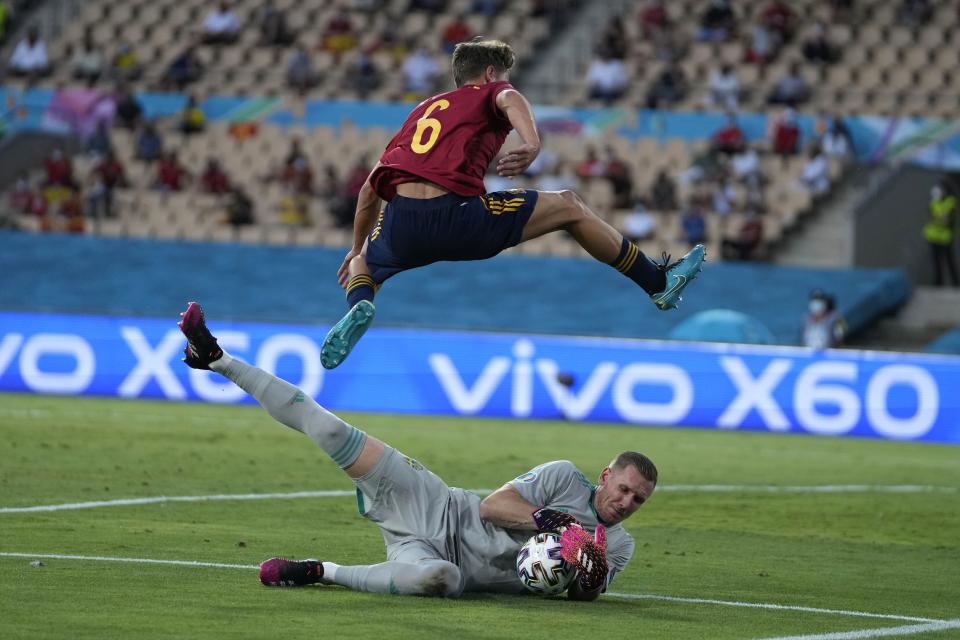 Sweden's goalkeeper Robin Olsen saves on an attempt to score by Spain's Marcos Llorente during the Euro 2020 soccer championship group E match between Spain and Sweden at La Cartuja stadium in Seville, Monday, June 14, 2021. (AP Photo/Thanassis Stavrakis, Pool)