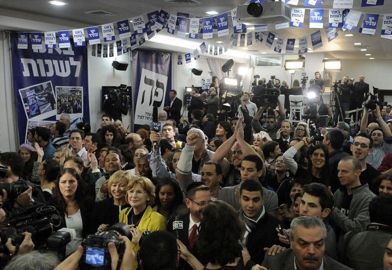 Supporters of Israeli actor, journalist and author Yair Lapid, leader of the Yesh Atid (There is a Future) party, react as the results of exit polls are announced giving the party 19 seats in the Knesset (on January 22, 2013 in Tel Aviv. Israeli Prime Minister Benjamin Netanyahu's Likud-Beitenu list was the top performer but weakened by the centrist Yesh Atid, according to TV exit polls