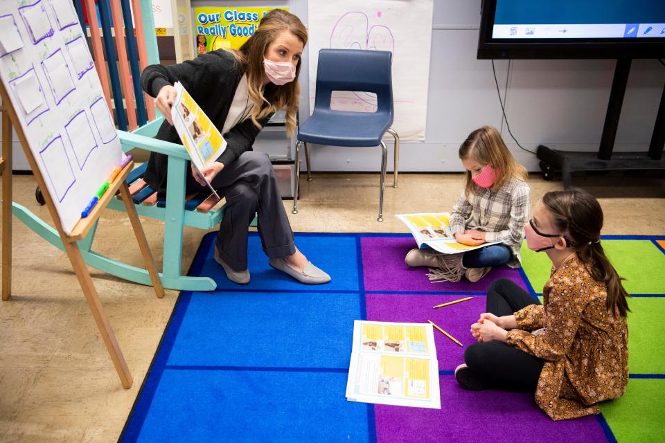 First grade teacher Kristin Bosco, left, works with a small group of students in her classroom at John Sevier Elementary in Maryville, Tenn., on Thursday, February 4, 2021. Bosco allows groups of up to eight virtual students to come into the classroom for in-person English-Language Arts learning from 8:30 to 11:30 in the morning.