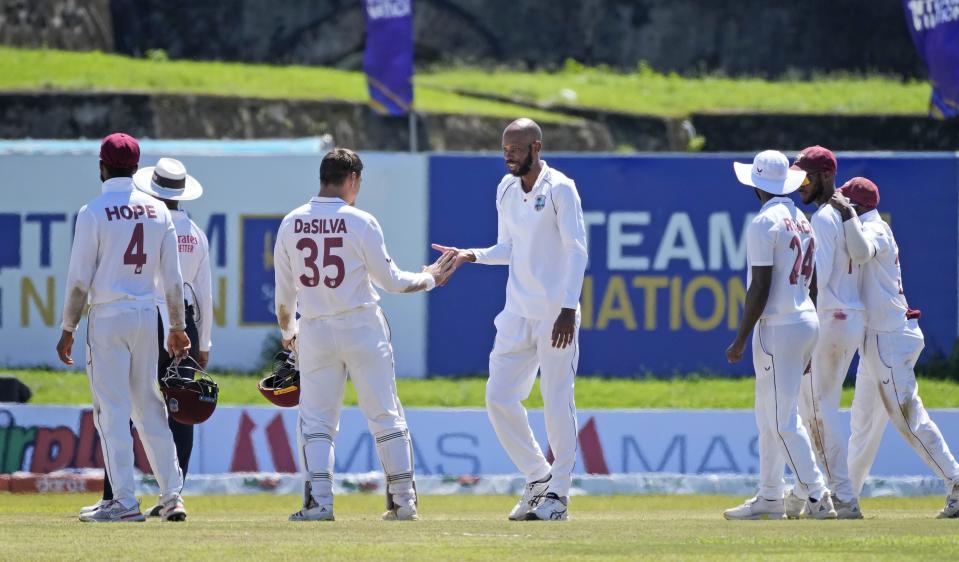 West Indies bowler Roston Chase, centre, is congratulated by his team mates for taking the wicket of Sri Lankan batsman Pathum Nissanka during the fourth day of their second test cricket match in Galle, Sri Lanka, Thursday, Dec. 2, 2021. (AP Photo/Eranga Jayawardena)