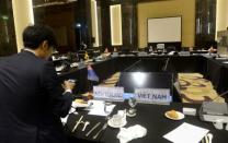 A reporter takes pictures with his smart phone at a meeting room after the TPP11 meeting, a gathering of Trans-Pacific Pact member countries, held on the sideline of the Asia-Pacific Economic Cooperation (APEC) 23rd Ministers responsible for Trade Meeting in Hanoi on May 21, 2017. REUTERS/Hoang Dinh Nam/Pool