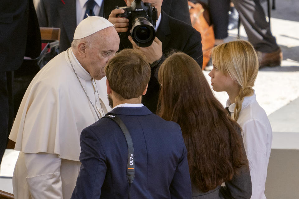 FILE - Kateryna Prokopenko, right, wife of Azov Battalion Commander Denys Prokopenko, and Yuliia Fedosiuk, second from right, from Ukraine, talk with Pope Francis, at the end of the weekly general audience, in St. Peter's Square at the Vatican, Wednesday, May 11, 2022. Francis has drawn criticism from some in the West for refusing to condemn Russia or President Vladimir Putin by name for launching the invasion, though he has stepped up his criticism of the atrocities Russian forces have committed against Ukrainian civilians and recently met with the wives of two Ukrainian soldiers holding out at the besieged steel mill in Mariupol. (AP Photo/Domenico Stinellis, File)