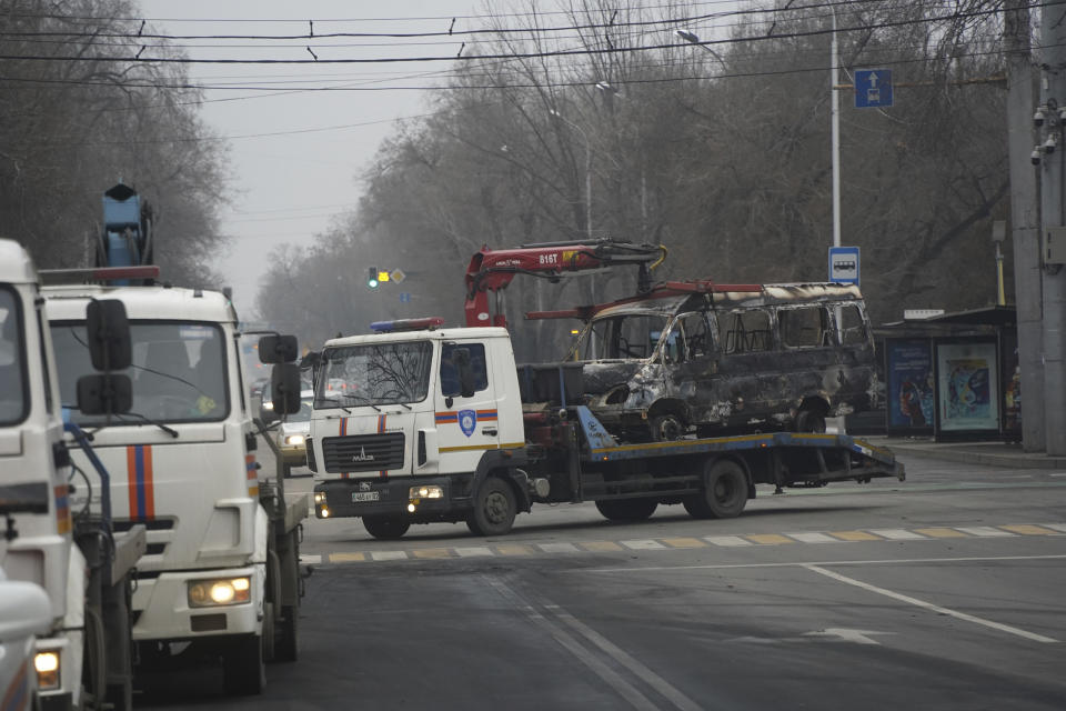 A tow truck transports a bus, which was burned during clashes in Almaty, Kazakhstan, Sunday, Jan. 9, 2022. Kazakhstan's health ministry says 164 people have been killed in protests that have rocked the country over the past week. President Kassym-Jomart Tokayev's office said Sunday that order has stabilized in the country and that authorities have regained control of administrative buildings that were occupied by protesters, some of which were set on fire. (Vladimir Tretyakov/NUR.KZ via AP)