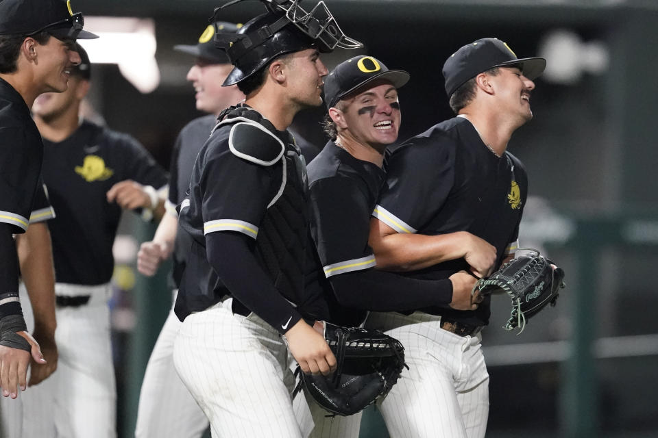 Oregon pitcher Logan Mercado, right, is congratulated by teammates after the team's 11-2 win against Xavier following an NCAA college baseball tournament regional championship game Sunday, June 4, 2023, in Nashville, Tenn. (AP Photo/George Walker IV)