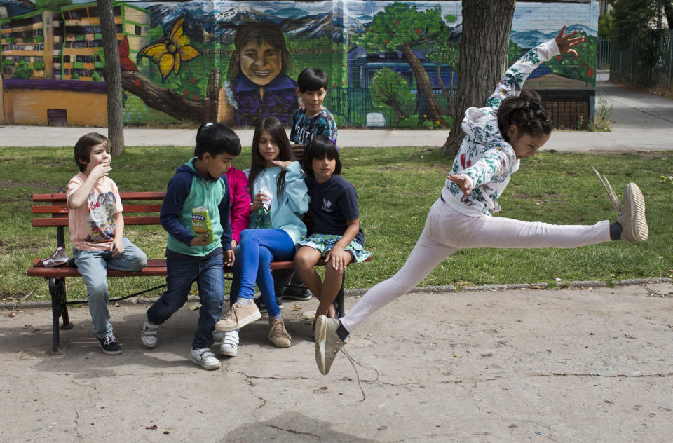 En esta imagen, tomada el 11 de diciembre de 2018, Violeta, una niña transgénero, salta durante un descanso en la escuela Amaranta Gómez, en Santiago, Chile. Los alumnos afirman que el centro les ha ayudado a aceptar totalmente su identidad. (AP Foto/Esteban Félix)