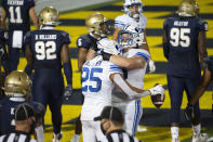 BYU running back Tyler Allgeier (25) celebrates with offensive lineman Clark Barrington (56) after scoring a touchdown during the second half of an NCAA college football game against Navy, Monday, Sept. 7, 2020, in Annapolis, Md. (AP Photo/Tommy Gilligan)