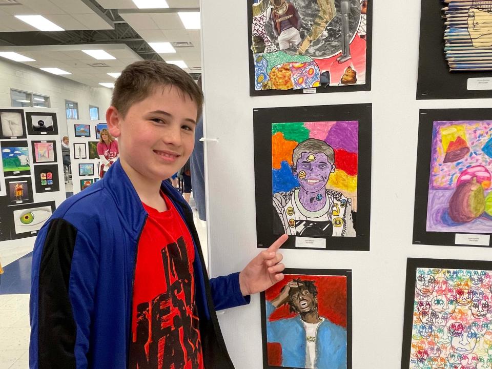 Seventh-grader John Moore shows off his artwork at the annual Fine Arts Night held at Hardin Valley Middle School Tuesday, April 12, 2022.