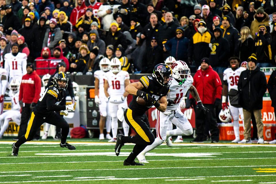 Iowa defensive back Cooper DeJean returns an interception for a touchdown against Wisconsin during a Nov. 12, 2022, game.