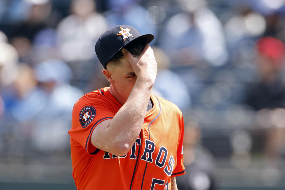 Houston Astros pitcher Hunter Brown reacts after the Kansas City Royals score two of their nine runs in the first inning of a baseball game in Kansas City, Mo., Thursday, April 11, 2024. (AP Photo/Colin E. Braley)