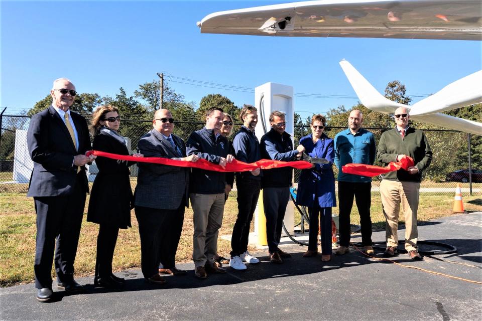 A ribbon-cutting ceremony was held at the Marshfield Municipal Airport on Friday, Oct. 13 for the installation of the state’s first-ever electric charging station for aircraft and ground vehicles. Those cutting the ribbon were, from left, MassDOT Aeronautics Administrator Jeff DeCarlo, Aid to State Rep. Josh Cutler Susan Moran, Marshfield Town Administrator Michael Maresco, state Senator Patrick O'Connor, Plymouth Area Chamber of Commerce Executive Director Amy Naples, Geoff Douglass (who spearheaded the project for Shoreline), Shoreline Aviation President Keith Douglass, FAA Regional Administrator Colleen D'Alessandro, BETA Technologies COO Blain Newton, and South Shore Chamber of Commerce Director of Local Affairs Eric Dykeman.