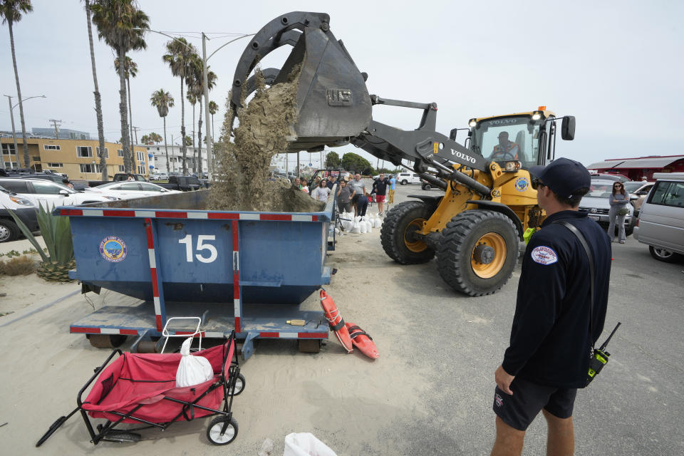 Residents wait in line to fill up their sandbags ahead of Hurricane Hilary, in Long Beach, Calif., Saturday, Aug. 19, 2023. (AP Photo/Damian Dovarganes)