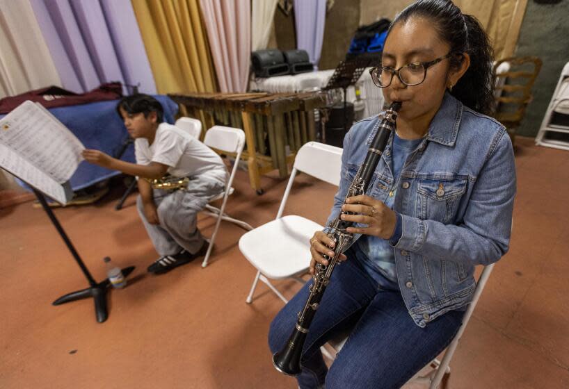 Daisy Herrera Beltran plays clarinet at Maqueos Music Academy, where students learn Oaxacan music, in Los Angeles on Feb. 2, 2024.