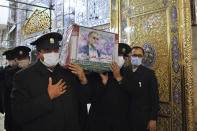 In this picture released by the Iranian Defense Ministry and taken on Saturday, Nov. 28, 2020, caretakers from the Imam Reza holy shrine, carry the flag draped coffin of Mohsen Fakhrizadeh, an Iranian scientist linked to the country's disbanded military nuclear program, who was killed on Friday, during a funeral ceremony in the northeastern city of Mashhad, Iran. An opinion piece published by a hard-line Iranian newspaper has suggested that Iran must attack the Israeli port city of Haifa if Israel carried out the killing of a scientist. (Iranian Defense Ministry via AP)