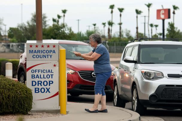 PHOTO: A woman drops her ballot at a an official ballot drop box during primary voting in Mesa, Ariz., Aug. 2, 2022. (Rebecca Noble/The New York Times via Redux)