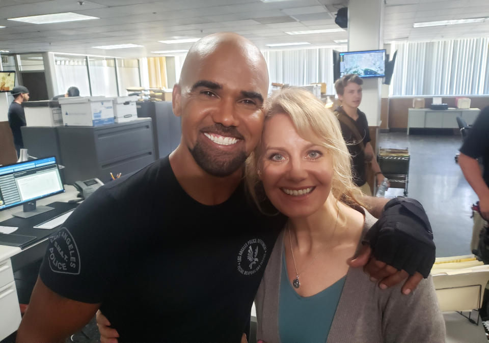 This image shows actress Eileen Grubba with actor Shemar Moore on the set of the C.B.S. series "S.W.A.T." on Aug. 27, 2019. NBCUniversal said Friday that actors with disabilities will be included in auditions for all new productions, an agreement sought by the Ruderman Family Foundation, a disability rights advocate. Grubba, an actor and disability activist, said NBCUniversal's action, coupled with that of CBS Entertainment, could lead to wider change. (Eileen Grubba via AP)