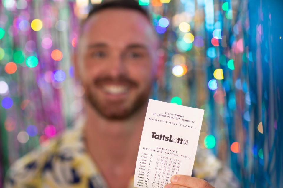 TattsLotto winner holds winning ticket