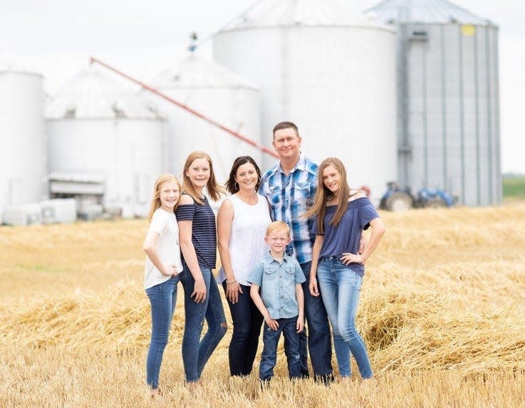 Brian Rexing and his family stand on their farm, New Generation Dairy in Owensville, Ind.