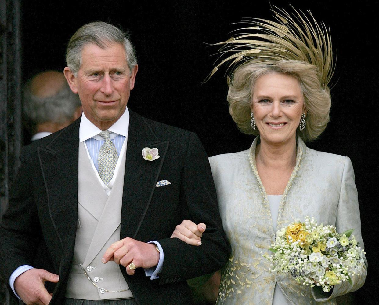 FILE - Britain's Prince Charles and his bride Camilla Duchess of Cornwall as they leave St George's Chaple in Windsor, England, April 9, 2005 following the church blessing of their civil wedding ceremony. 