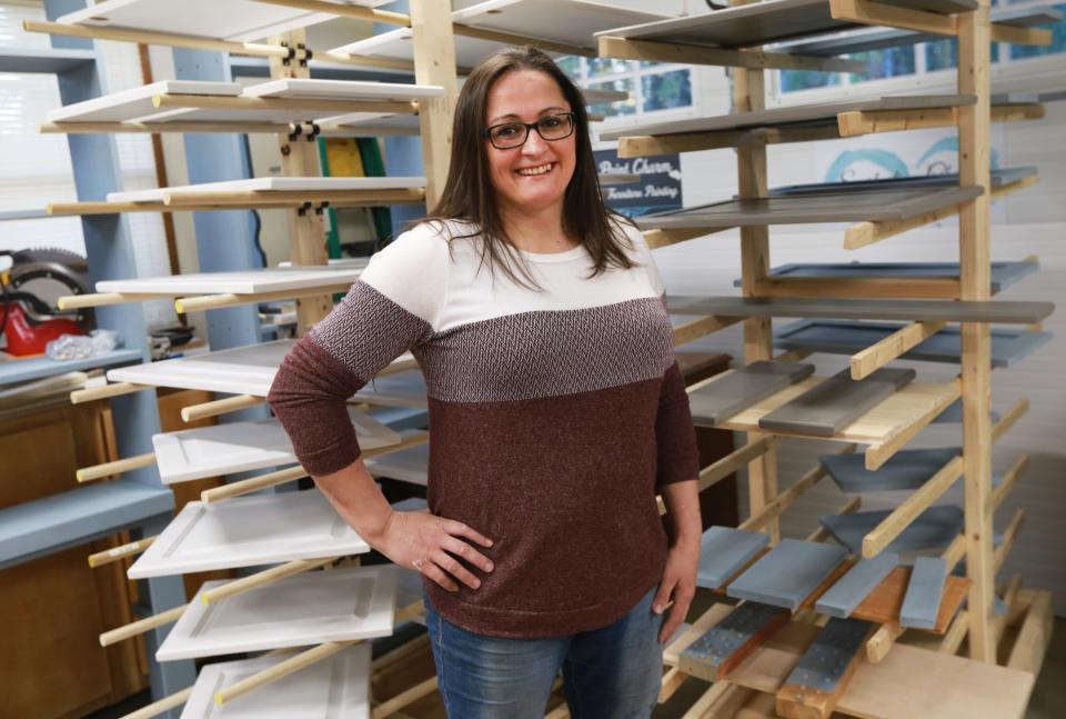 Maria Viveiros Ferreira, owner of Everlasting Charm Cabinetry & Furniture Refinishing, works in her shop on Thursday, April 28.