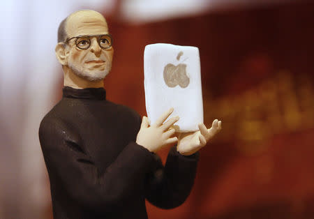 A figure of Apple founder Steve Jobs is seen in a craft shop in Naples, Italy, in this October 7, 2011 file photo. REUTERS/Ciro De Luca/Files