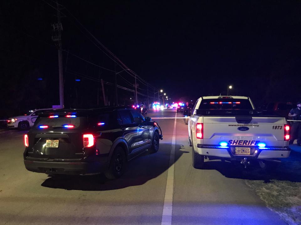 Law enforcement vehicles and crime scene tape marked off a roughly quarter-mile stretch of 45th Street where officials said deputies shot a 19-year-old who ran from a car stopped for questioning about gunfire reported in the area early June 11, 2022.