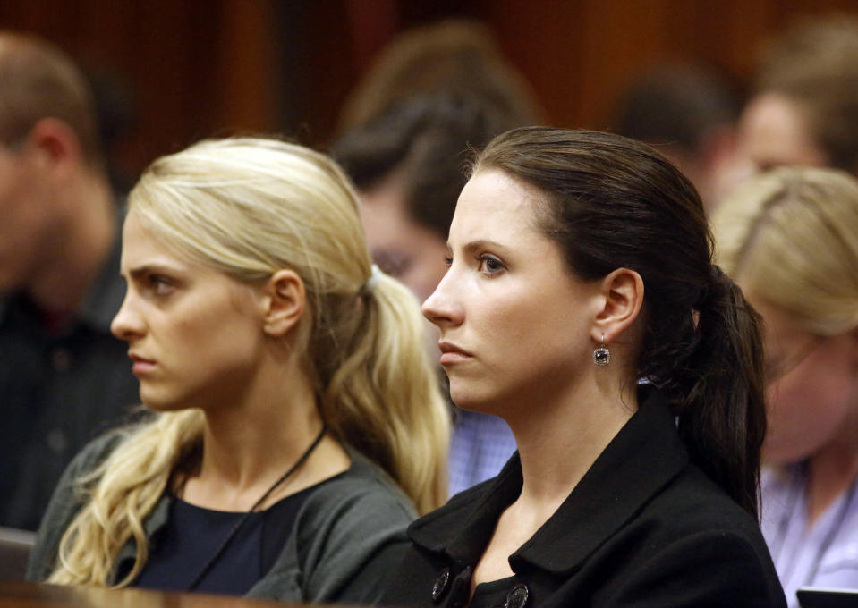 Sister of Oscar Pistorius, Aimee, right, listens to cross questioning in court during his trial at the high court in Pretoria, South Africa, Friday, March 7, 2014. Pistorius is charged with murder for the shooting death of his girlfriend, Steenkamp, on Valentines Day in 2013. (AP Photo/Schalk van Zuydam, Pool)