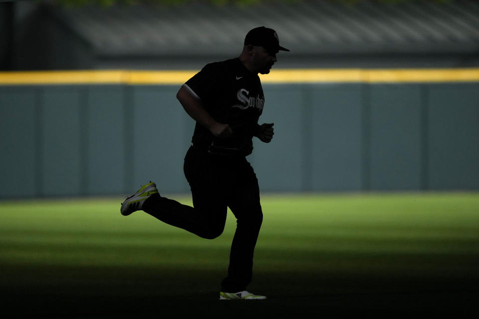 Chicago White Sox relief pitcher Liam Hendriks enters a baseball game in silhouette during a flickering of the stadium lights to start the eighth inning against the Los Angeles Angels, Monday, May 29, 2023, in Chicago. (AP Photo/Charles Rex Arbogast)