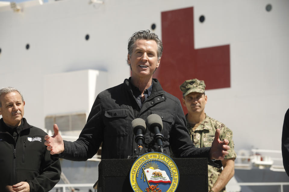 LOS ANGELES, CA - MARCH 27: California Governor Gavin Newsom speaks in front of the hospital ship USNS Mercy that arrived into the Port of Los Angeles on Friday, March 27, 2020,  to provide relief for Southland hospitals overwhelmed by the coronavirus pandemic. Also attending the press conference were Director Mark Ghilarducci, Cal OES, left, Admiral John Gumbleton, United States Navy, right, and many others not shown including Mayor Eric Garcetti and  Dr. Mark Ghaly, Secretary of Health and Human Services. (Photo by Carolyn Cole-Pool/Getty Images)