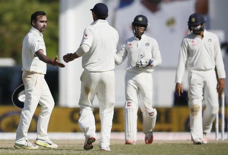India's Amit Mishra (L) celebrates with his teammates after taking the wicket of Sri Lanka's Tharindu Kaushal (not in picture) during the third day of their second test cricket match in Colombo August 22, 2015. REUTERS/Dinuka Liyanawatte