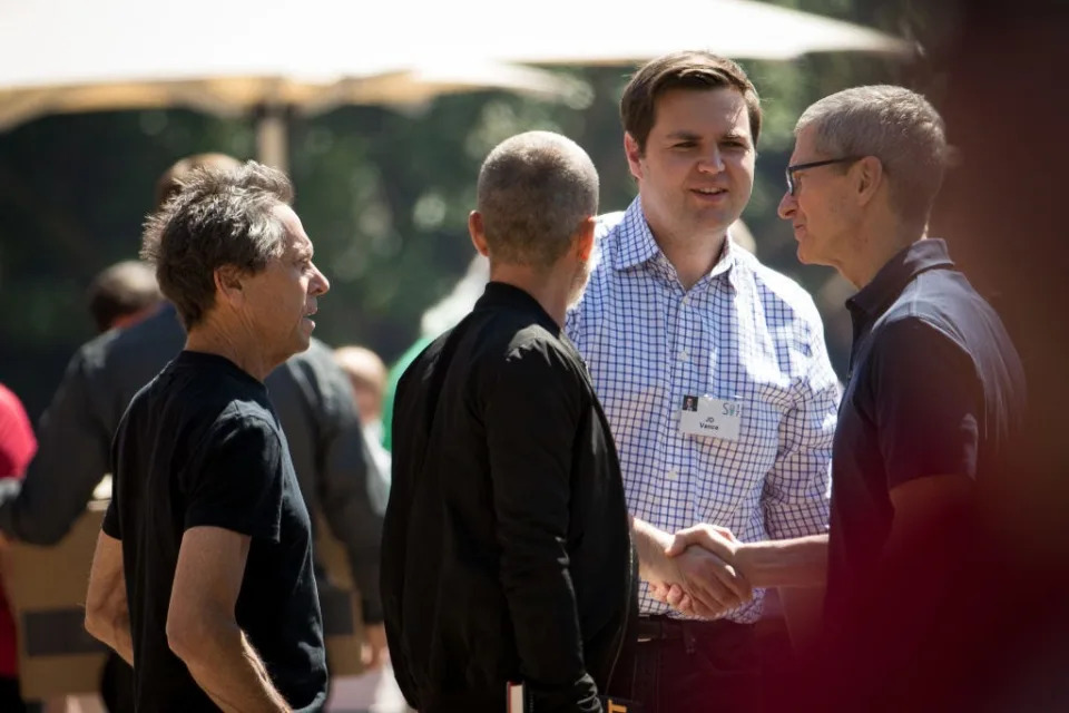 JD Vance shakes hands with Tim Cook.