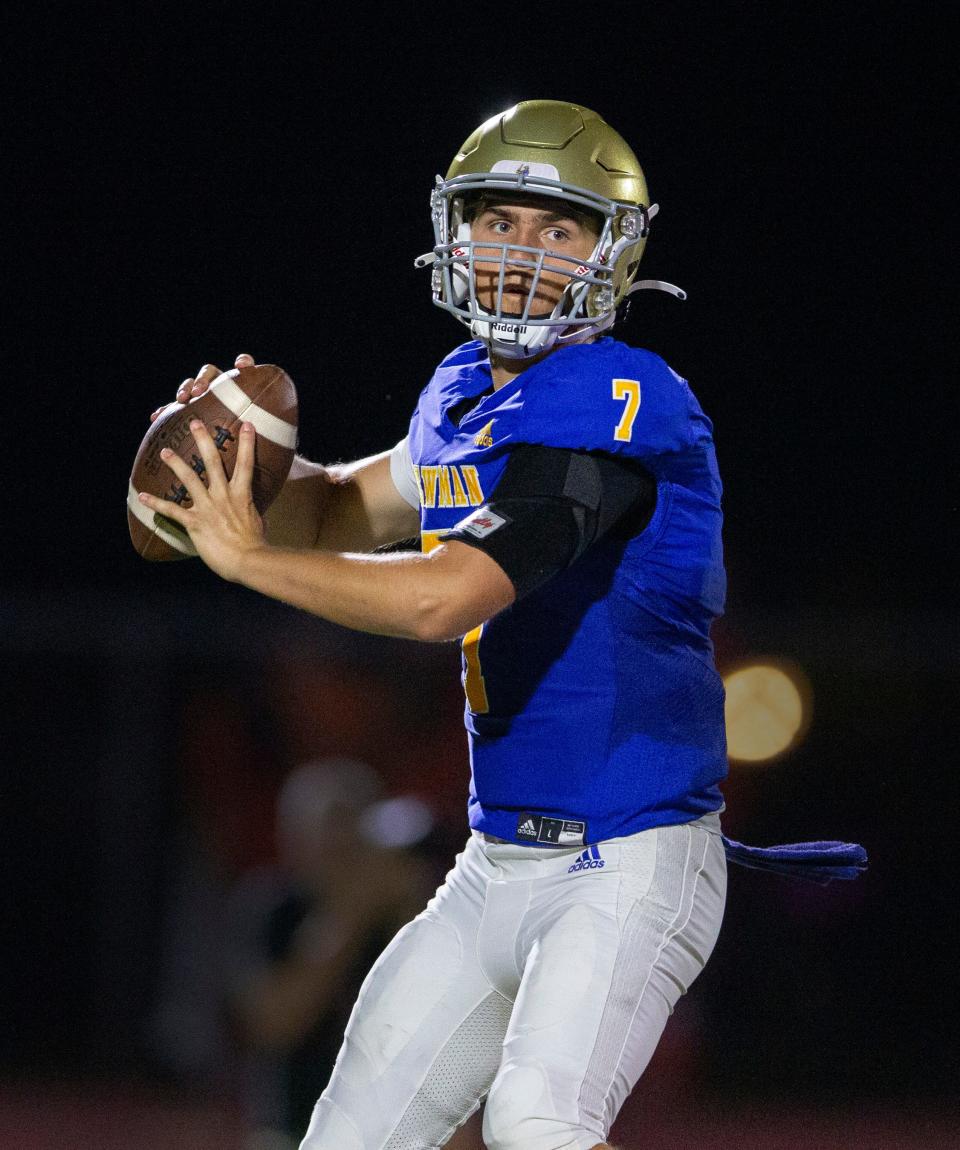 Cardinal Newman quarterback Luke Warnock looks for an open receiver against Benjamin during their football game on October 20, 2023 in West Palm Beach, Florida.